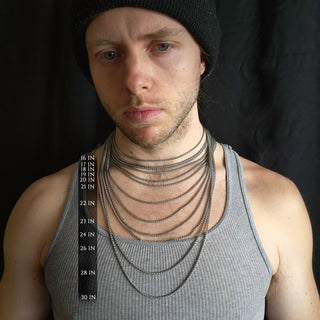 Chains of various lengths worn on a single person