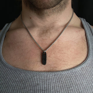 Black Ovular Stainless Steel Pendant on Bare Skin of Sternum