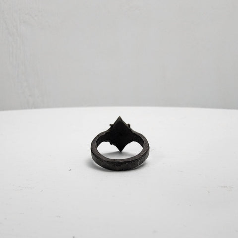 Black stainless steel star ring with a round sapphire set in the center