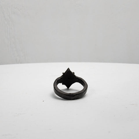 Black stainless steel star ring with a round sapphire set in the center