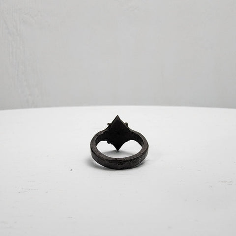 Black stainless steel star ring with a round sapphire set in the center