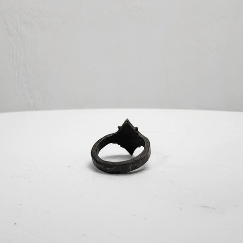 Black stainless steel star ring with a round sapphire set in the center