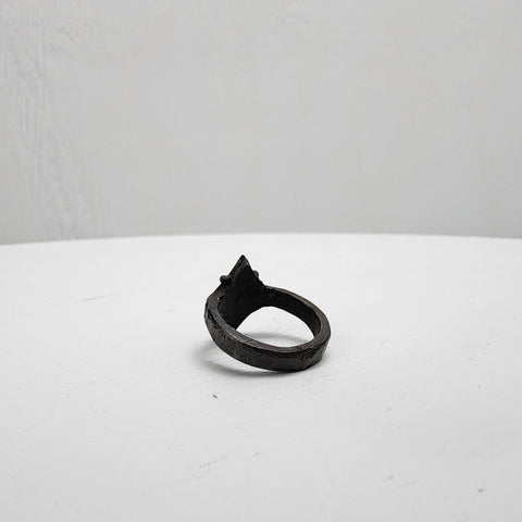 Black stainless steel star ring with a round sapphire set in the center