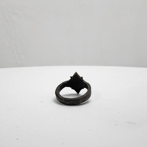 Black stainless steel star ring with a round sapphire set in the center