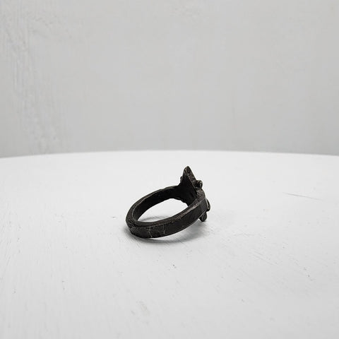 Black stainless steel star ring with a round sapphire set in the center