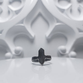 Black stainless steel ring with an elongated face with ends coming to a point