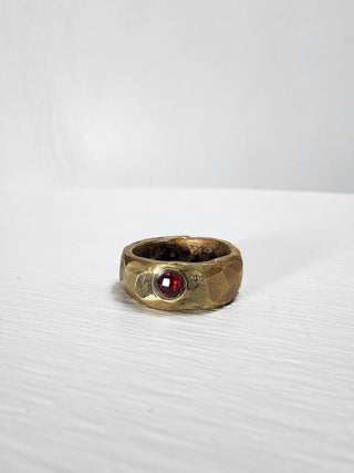 Polished and hammered brass band with ruby gemstone