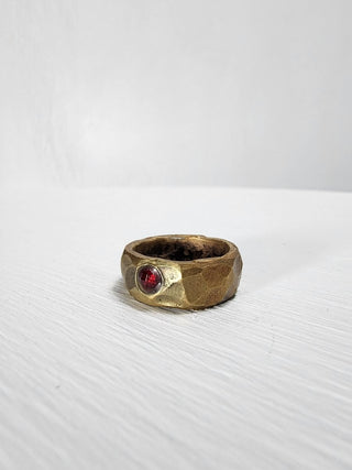 Polished and hammered brass band with ruby gemstone