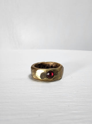 Polished and hammered brass band with ruby gemstone