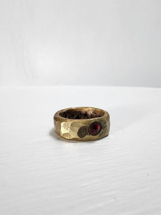 Polished and hammered brass band with ruby gemstone