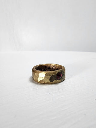 Polished and hammered brass band with ruby gemstone