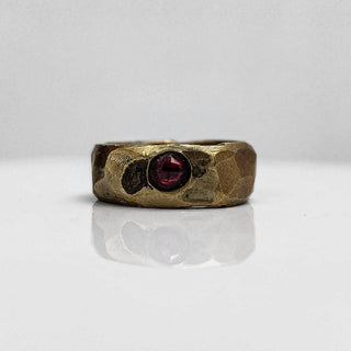 Polished and hammered brass band with ruby gemstone