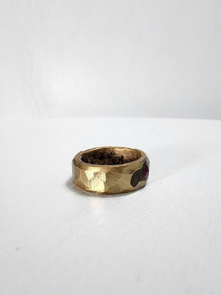 Polished and hammered brass band with ruby gemstone