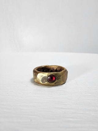 Polished and hammered brass band with ruby gemstone