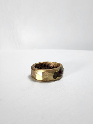 Polished and hammered brass band with ruby gemstone