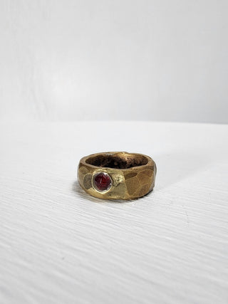 Polished and hammered brass band with ruby gemstone