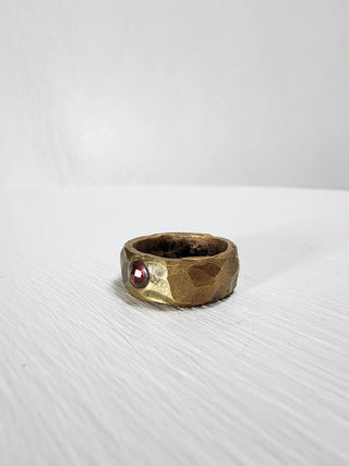 Polished and hammered brass band with ruby gemstone